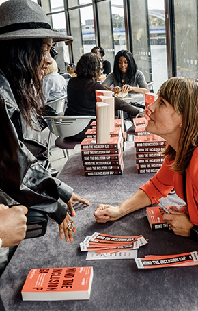 Suzy signing books and talking to people